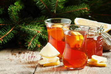 Hot tea with ginger, honey and lemon in oriental glasses on the