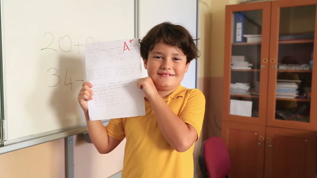 Student Showing A Paper With Perfect Grade A Plus