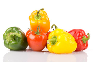 Water drops on freshness vegetables: green, orange, yellow, red, paprika and tomatoes on white isolated background.