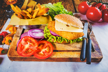 Set dish Chicken burger with fresh vegetables and fried chips