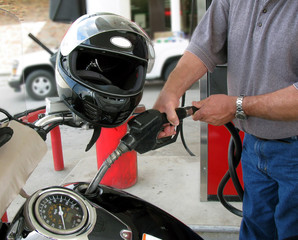 Fototapeta premium Adult Male Fueling a Motorcycle