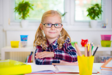 Pretty girl in glasses learns at school