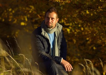 Young man in the autumn forest