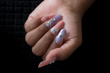 Manicure nail design on woman's hand.