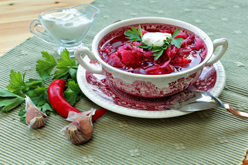 Borsch in vintage bowl with parsley, sour cream