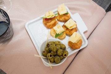 Green olives, slices of bread and cheese