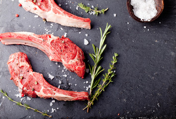 Raw meat, mutton, lamb rack with fresh herbs.