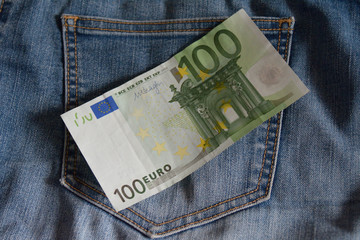 100 euros lying over the jeans pocket