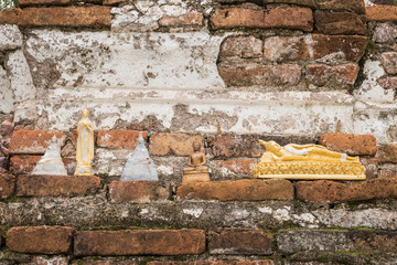 Buddha statue on old brick wall background in the temple