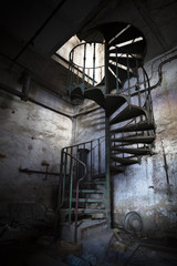 spiral staircase in an abandoned factory building © fotopic