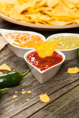 Plate of nachos with different dips