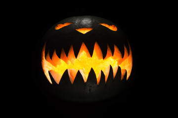 Spooky pumpkin in dark, isolated on black background