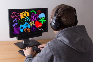 back view of young man using a computer and listening music