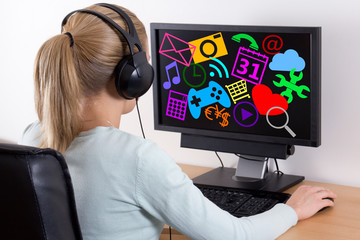 internet concept - back view of young woman using a computer and