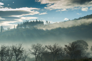 Foggy mountain landscape on early mornig