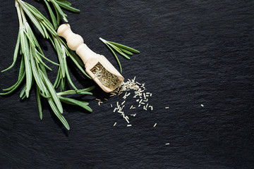 Fresh and dry rosemary on a slate plate