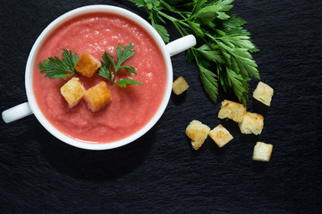 Vegetable soup with beetroot, croutons and parsley