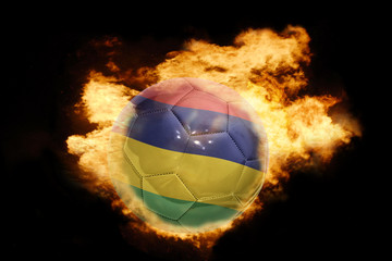 Fototapeta premium football ball with the flag of mauritius on fire