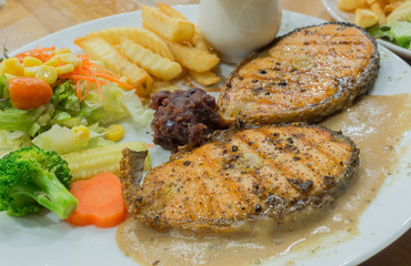 Grilled salmon steaks in white plate