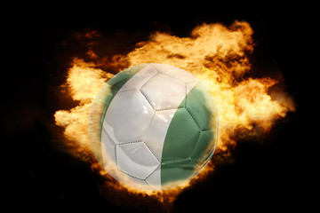 Naklejka premium football ball with the flag of nigeria on fire
