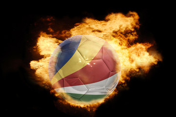 Fototapeta premium football ball with the flag of seychelles on fire