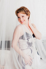 Smiling woman in her bed in the morning © OlgaKhorkova