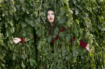 girl is under the mulberry branches as being sprayed with water