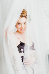 Beautiful woman sitting in bed © OlgaKhorkova