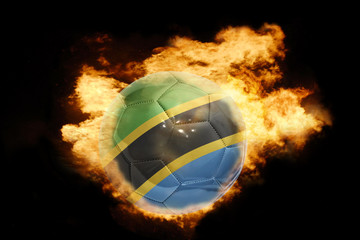 football ball with the flag of tanzania on fire