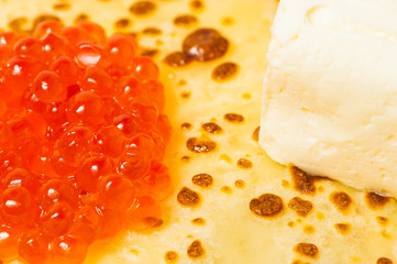 some pancakes on the white plate with red caviar
