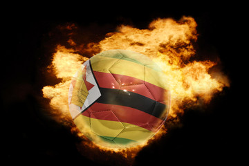 football ball with the flag of zimbabwe on fire - Powered by Adobe