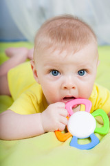 portrait of little kid  with teether in the mouth