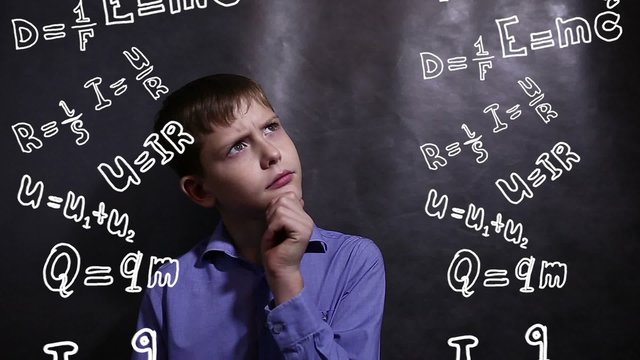 Teen boy thinks formula physics science scientist genius