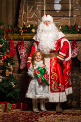 Father Frost and Snow Maiden standing at the Christmas tree with