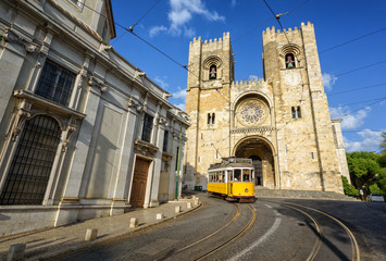 Old tram in front of cathedral in Lisbon, Portugal