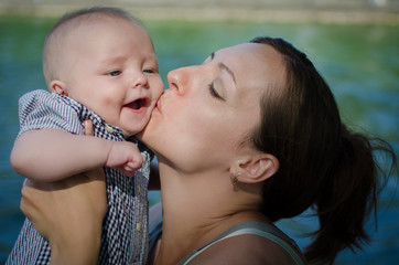 Mother kisses her little son