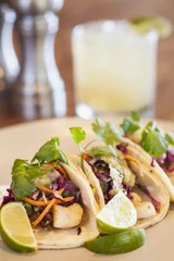 Tuinposter halibut tacos with avocado salsa verde and a margarita © Chuck Place