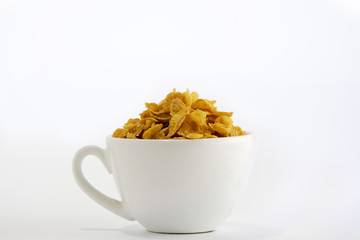 Cornflakes in a white cup breakfast