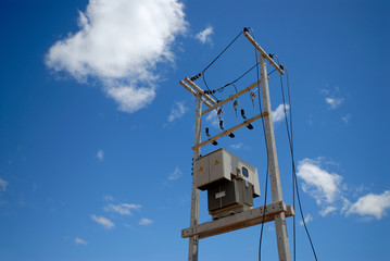 electrical transformer on pole with blue sky background