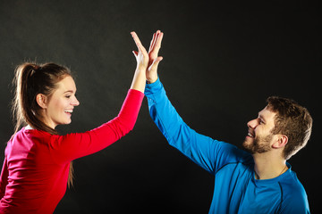 Friends man and woman celebrating giving high five