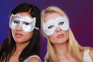 Two women face with carnival venetian masks