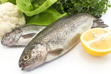 Two rainbow trout with vegetables and lemon