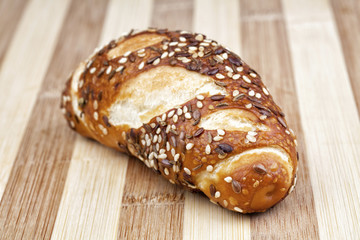 Kind of Bavarian bread with cumin, sesame and linseed photographed on wooden table. Studio shot.
