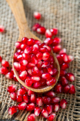 pomegranate seeds on wooden surface
