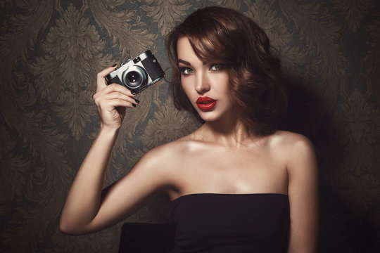 Beautiful Woman With Vintage Camera