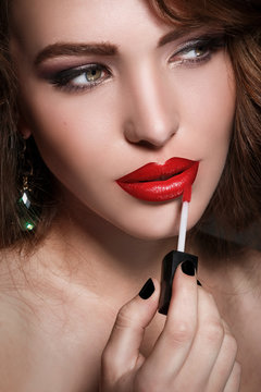 Woman Applying Red Lipstick