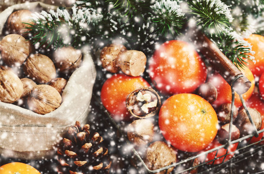 Christmas decoration with tangerines, xmas tree twigs and snowflakes