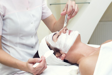 woman passes treatment mask facial at the beauty salon