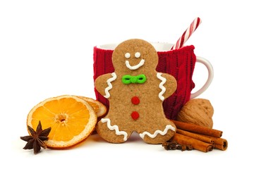 Christmas gingerbread man with festive mug and holiday spices isolated on white