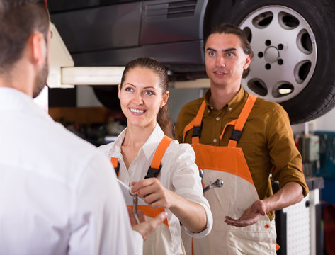 Mechanic Handing Over Keys From A Car